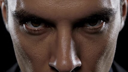 Intense close up shot capturing the stern expression on the face of a determined man, conveying both determination and anger through his furrowed brows and piercing gaze