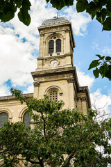 A tall building with a clock tower and a dome on top