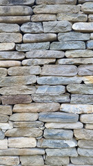 Close view of dry stacked fieldstone wall with varied textures