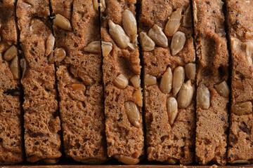 Slices of delicious homemade bread with sunflower seeds, closeup.