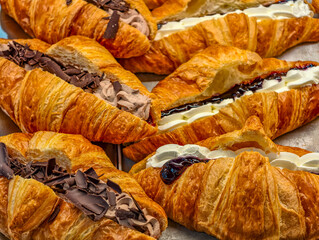 Fresh Croissants Variety Display Chocolate Cream Filled Pastries Bakery Shop French Viennoiserie Breakfast Food Background Flaky Layered Golden