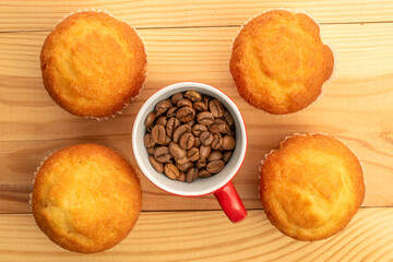 Delicious muffins  on a wooden table, top view, close-up.