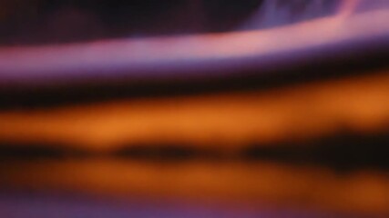 Abstract purple waves reflecting golden particles and light trails - Powered by Adobe