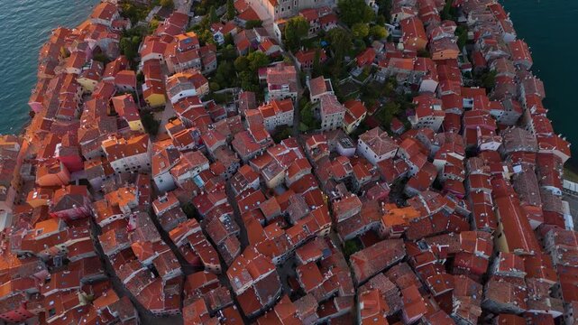 Cinematic Aerial View of Rovinj Old Town, Croatia &ndash; Golden Sunset Over Adriatic Sea with Red Rooftops, Historic Architecture and Peaceful Mediterranean Atmosphere