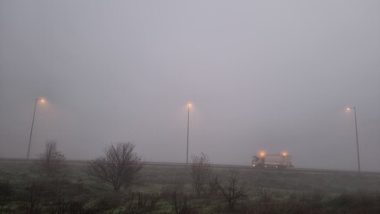 fog road lights car in autumn travel