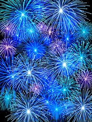 Bright blue and purple fireworks explode in the night sky