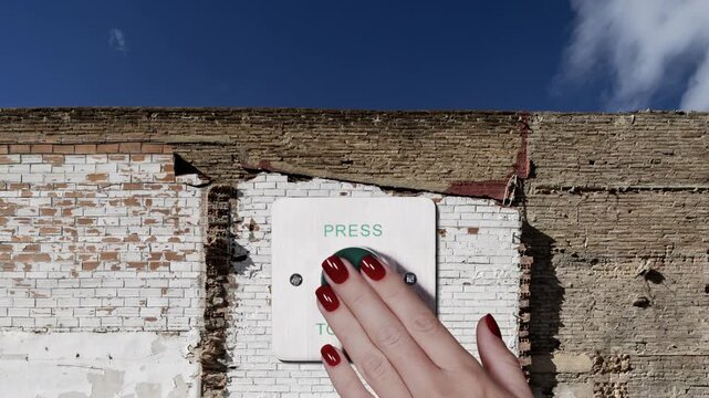 wall and hand pressing large exit button