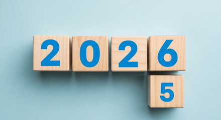 Fototapeta premium 2025 to 2026 transition on wooden blocks, a year progression concept for the future