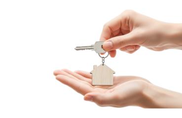 Hand giving a house key with a wooden house charm to another hand