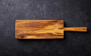Wooden cutting board. Dark grey background. Copy space. Top view.