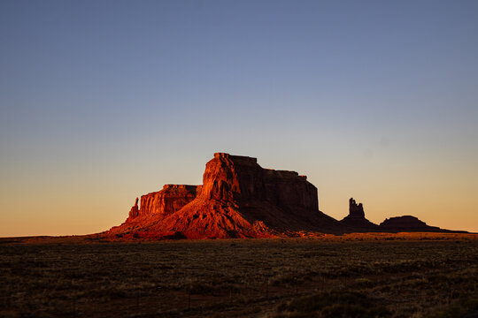 Monument Valley Buttes in Dramatic Golden Hour Light at Sunset - Powered by Adobe