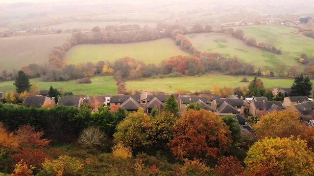 Semi rural English Suburb houses and farmland on Autumn misty day