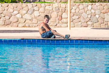 A boy near a pool at a hotel in Egypt