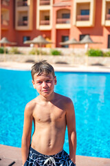 A boy near a pool at a hotel in Egypt