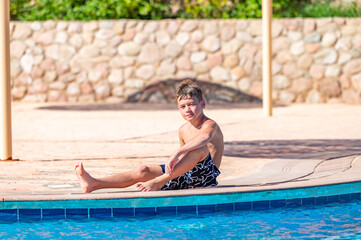 A boy near a pool at a hotel in Egypt