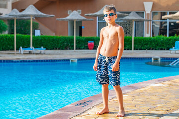 A boy near a pool at a hotel in Egypt