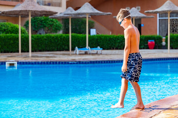A boy near a pool at a hotel in Egypt