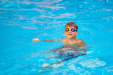 happy boy swimming in the pool