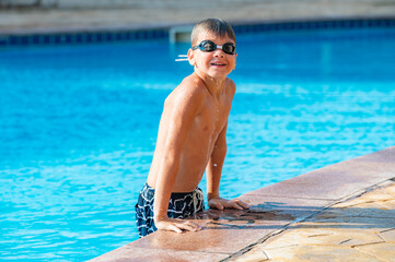 happy boy swimming in the pool