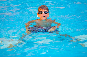 happy boy swimming in the pool