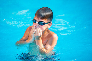 happy boy swimming in the pool
