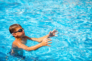 happy boy swimming in the pool