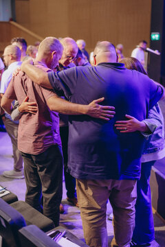 A Group of Christians pray to bless and pray for each other in church
