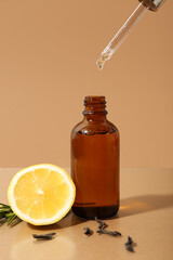 Bottle of essential oil and natural ingredients on color background