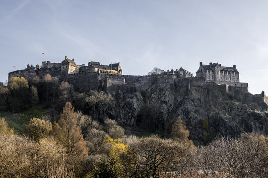 View of Edinburgh Castle perched atop an ancient volcanic rock, overlooking the city with a blend of grey stone and the changing colors of spring, Edinburgh, Scotland, United Kingdom.