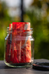 Swiss franc CHF banknote saving money in glass jar. Consumption and economy