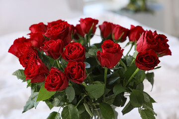 Bouquet of beautiful red roses in room, closeup