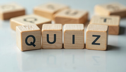 Wooden blocks form the word quiz. Letters Q U I Z sit on a light surface. Education concept explores questions tests and challenges. Game play.