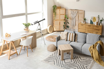 Interior of living room with telescope, sofa and workplace