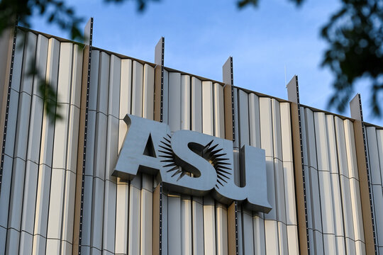 Close-up of the ASU logo mounted on the vertical facade of the Sidney Poitier New American Film School building, symbolizing university branding and contemporary academic architecture