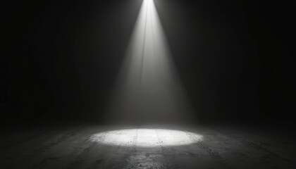 Single bright spotlight shines down on dark concrete floor. Strong beam creates circular light patch. Dramatic illumination fills empty stage space, providing abstract glow and mystery.