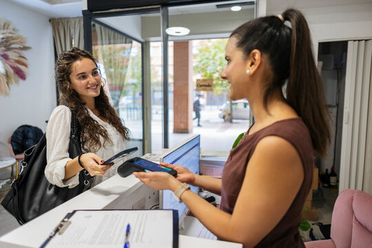 Customer paying with smartphone using contactless terminal
