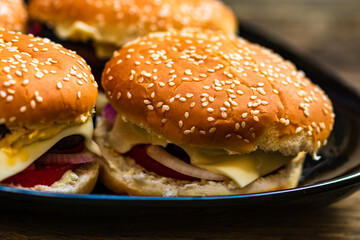 Closeup of fresh homemade tasty burgers on wooden table