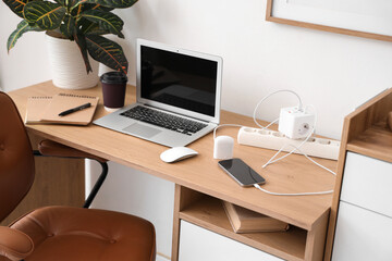 Workplace with gadgets and charger in office