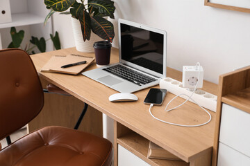 Workplace with gadgets and charger in office