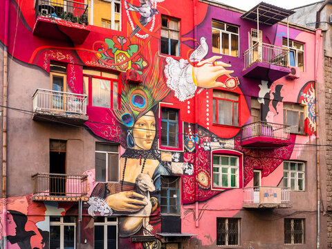 Yerevan, Armenia - September 20, 2025: modern graffiti on pink tuff facade of urban house on Northern Avenue in Yerevan city in autumn evening