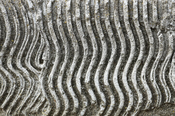 Texture of ribbed stone as background, closeup