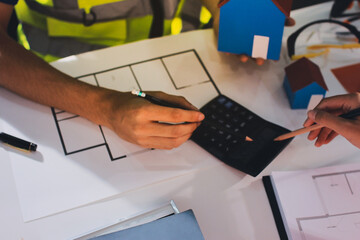 Closeup of team of industrial engineers meeting analyze machinery blueprints consult project on table in manufacturing factory. Working in manufacturing plant or production plant.