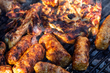 Pork chops, steak, sausages on barbecue grill