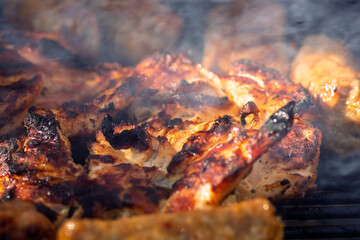Pork chops, steak, sausages on barbecue grill