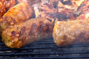 Pork chops, steak, sausages on barbecue grill