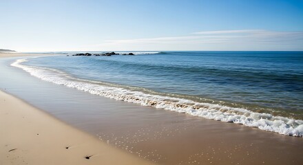 Serene Beach Landscape with Gentle Waves and Clear Blue Sky.