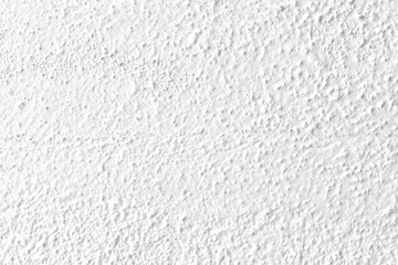 White concrete wall texture background. Uneven render stucco white painted concrete wall texture background. Rough and grunge wall in the sun.