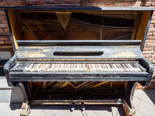 old piano on street on sunny summer day