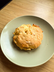 Homemade apple pie on plate near window in natural light. Comfort food, home baking, and cozy atmosphere of simple lifestyle.
