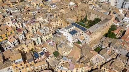 Aerial view of the small church of Santo Spirito, located in the historic center of Agrigento, Sicily, Italy. It is an ancient Catholic place of worship with a large walled courtyard.